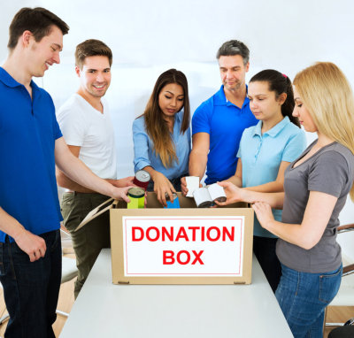 six people putting things on donation box