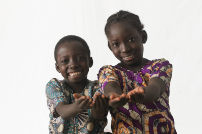 Two African children showing their palms asking begging for some